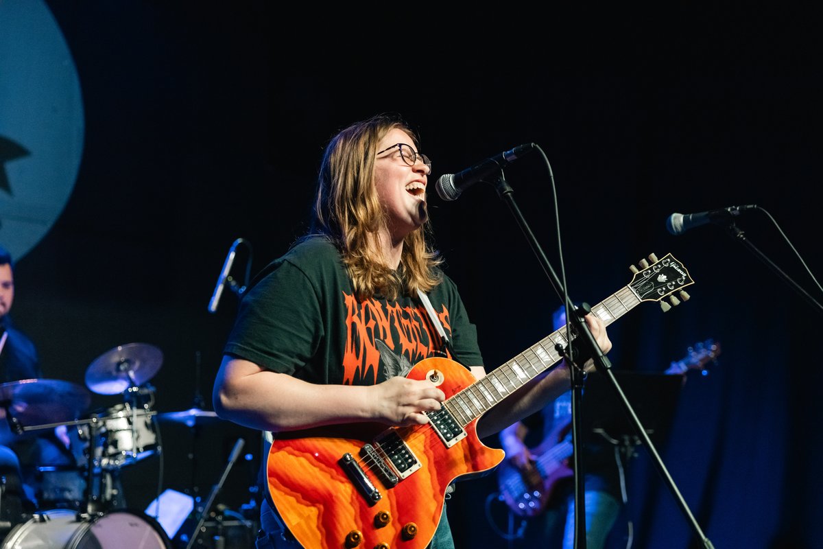 Quarter Bend student Becca performing on stage